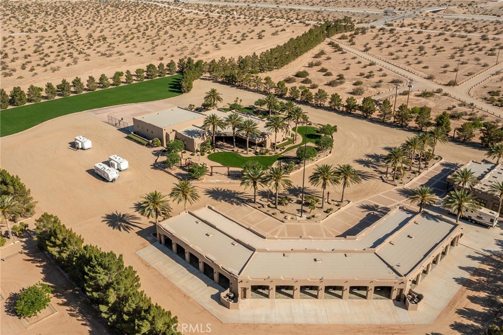 An adventure lover’s paradise that merges high-octane thrills with luxurious comforts. Incredible 400-acre Dune Ranch featuring private runways, hangars, a half-mile racetrack, multiple sand cars, tractors, and more. The fully furnished 8,144 sq. ft. main house includes a 2,100 sq. ft. game room (games included—see photos) plus an attached 1,223 sq. ft. casita. The main house has a 3-car attached garage and an additional 2,034 sq. ft. garage stocked with ten Polaris RZR RS1s (all included). A private bungalow building offers two fully furnished 1-bedroom/1-bath units and a 2,432 sq. ft. garage filled with kid-size Razors, quads, and riding gear(all included). A 2,316 sq. ft. caretaker’s home with a large carport is also on-site.
You’ll find 13 High Performance Sand Cars(all included except the 57 chevy car not included) housed in a 7,115 sq. ft. garage with an attached 3,461 sq. ft. covered carport. There’s more: a 7,200 sq. ft. shop, a 3,240 sq. ft. man cave, a 4,800 sq. ft. hangar, and a 13,700 sq. ft. container building. Numerous tractors (Caterpillar, Massey, John Deere, Case, etc.), water trucks, Kubota utility vehicles, Kawasaki Mules, and other equipment are included (some items excluded in pictures). Water is supplied by Two 350 GPM wells. The property comprises multiple parcels, offering direct access to the Glamis dunes. Perfect for corporate retreats or large gatherings with Friends/Families. For a tour or a complete list of included items, contact Dug Mitchell Realty Co Covina Calif