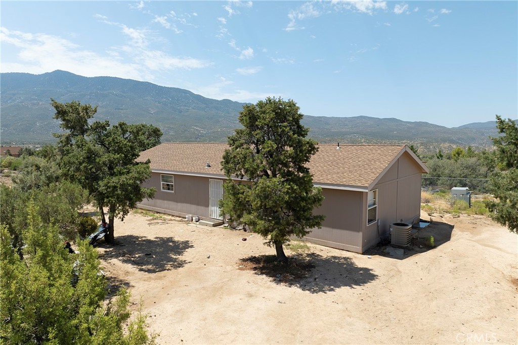Nice Fleetwood-made manufactured home has a tiled entry and open 15'x12' dining and 15'x12' living room. The dining area is separated from the kitchen with a breakfast bar. The home features a 11'x9' third room which is currently setup as a bedroom. The 14.5'x12.5' master bedroom has a walk-in closet and separate tub and shower in bathroom. The third bedroom measures 11.5'x9.5'. Indoor laundry room features plenty of cabinet space and 220v electrical. Private well with 5,000 gallon storage. The well certification has already been performed. Property sits on an acre of flat, usable land and there is an adjacent 1-acre parcel that's available separately. Not too far from Temecula and a short drive from Palm Springs and the Desert Hills Premium Outlets. Enjoy beautiful year-round weather in a private setting with lots of potential.