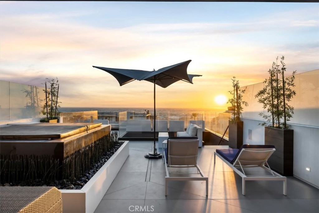 A dynamic Modernist home with an immersive oceanview experience in prime North Hermosa Beach. Designed by award-winning architect Michael Lee and constructed by fine Beach Cities home builder Kim Komick, this bold 4-story residence has striking beach and water vistas from nearly every floor, with abundant glass walls and sculpted terraces. It’s approximately 4,431 s.f., with 4 bedrooms and 6 bathrooms, including a penthouse primary suite with a fireplace and showroom closet, where you wake to horizon views and ocean air, and relax on a sprawling terrace with an outdoor spa and private lounge. Views are forever, due to an unblocked address across from 23rd St walk street, where you head out for spontaneous swim and surf sessions. At 2240 Hermosa Avenue, the neighborhood is roomy and residential, yet Pier Avenue dining and shopping is an easy 10-min stroll, and Downtown Manhattan Beach is just a 5-min bike ride along the Strand. In the sunny interior, oceanview living spaces abound. Dine over color-burst Pacific Ocean sunsets and a flickering fireplace in the glossy designer kitchen, dressed in luxury NEFF cabinets and PureLine appliances by Miele. Entertain in the open-air oceanview living room with a sleek wine wall, cut-out glass ceiling and adjoining terrace. Gather for movies in an elevated family room with blue-water views, or host beachside bashes in the crisp white beach room with a butler’s kitchen and private deck. Spaces flow easily and elegantly, from a sun-graced grand foyer with French oak floors and a floating staircase, to tucked-away designer bedroom suites with moody lighting and a hyper-minimalist vibe. Line and scale have all been superbly arranged by the architect, a Modernist leader in beach design, to fuse a constant connection to sand and sea, and provide a dramatic perch to enjoy this superb slice of Southern California coastline.