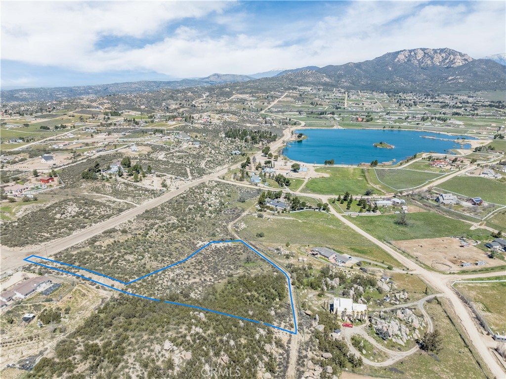 This flag lot is conveniently located just a short two-minute walk from the picturesque Lake Riverside and community center. Lake Riverside Estates community offers attractive amenities which include fishing and boating, horse trails, an equestrian center, bicycle pump track, basketball and volleyball courts, swimming pool, gated entry, and a private airstrip. The lot itself is currently in its natural state, consisting of rock outcroppings, a variety of native flora including desert sage and manzanitas, and a small seasonal creek. Aguanga offers an abundance of space and quiet, while still being conveniently located just 25 minutes from Temecula. Come build your dream home in this growing community, surrounded by the natural desert landscaping and stunning lake and mountain views.