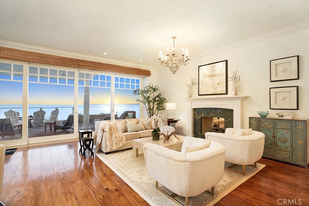 An Oceanfront Dream on one of the Most Scenic Beaches in the World. This home is a fresh and bright Cape Cod inspired Luxurious Estate that is the most perfect beach house! Enjoy three generous levels on the Oceanfront while listening to the waves. The decor is timeless and inviting, with lovely white trim casework throughout and fabulous design details at every turn. The designer kitchen is stunning, with gorgeous countertops and lovely white cabinets. The breakfast area sits next to exterior doors where you can gaze at the waves. There are 5 ensuite bedrooms, a Massage Room, a full Gym, a separate Office, an Art Room, an upper Den, a Main Floor Bedroom, an upstairs laundry, and a complete Theatre. The downstairs massage room can be turned into a 6th bedroom with its adjoining bath. The lower level Great Room boasts a beautiful bar area, an inviting sitting area with TV, and a Billiard area. Gorgeous wood floors on the main level and upper hallways. A pool and spa lead directly to the ocean path heading to the sand. You can sit and watch the beach-goers below. An elevator travels to all three floors and the home enjoys a 3-car garage. There is also a walk-in pantry that is perfect for storage. The neighborhood includes an amazing Clubhouse which features an enormous gym, a pool and an entertaining area that is superb for having gatherings and parties. Just relax and enjoy! The Strand is a magnificent guard-gated community just south of the Ritz Carlton Resort.