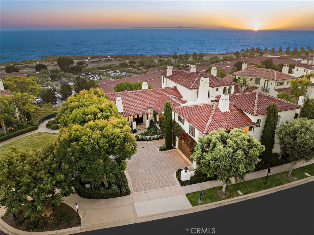 Uniquely positioned on the front row of guard-gated Crystal Cove, 80 Sidra Cove offers the epitome of refined and easy coastal living on a rare corner location with a private (not shared) driveway and three-car garage, ensuring ultimate convenience and security. In arguably the BEST location within the 86-home Seascape Villas, this exquisite 4-bedroom, 5-bathroom turnkey residence spans 3,889 +/- square feet, with sweeping, panoramic ocean views that stretch from Catalina Island to San Clemente Island. Located on a serene bluff, this home perfectly captures the essence of Southern California’s relaxed elegance and unmatched beauty. The residence has been recently refreshed, featuring a gourmet kitchen with new Porcelain countertops, Viking and Sub-Zero appliances, new flooring, new doors with Emtek hardware and upgraded bathroom vanities throughout. The spacious primary suite is a private sanctuary, offering ocean views, a soaking tub, and luxurious details that create a serene escape. The separate guest casita is an ideal retreat for visitors, while the home’s expansive outdoor spaces, complete with a sun-drenched lounge area, offer the perfect setting for entertaining or simply relaxing while enjoying breathtaking sunset vistas. Beyond the walls of this remarkable home, Crystal Cove is renowned for its world-class amenities and effortless luxury, providing a lifestyle like no other. Residents enjoy access to the exclusive Canyon Club, which boasts tennis and basketball courts, a resort-style pool, a state-of-the-art fitness center, and meeting facilities. The community also offers beach access, allowing you to walk to the shore and soak in the beauty of the Pacific Ocean. With top-notch, guard-gated security and proximity to world-class shopping, dining, and the renowned beaches of Newport Beach and Laguna Beach, Crystal Cove seamlessly blends luxury with convenience. With every detail designed to enhance your lifestyle, 80 Sidra Cove invites you to experience extraordinarily convenient coastal living in one of the most coveted communities in Southern California.