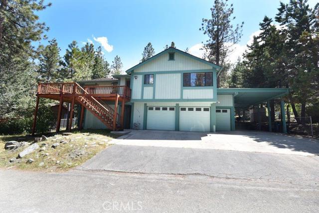 Beautiful Two-Level Home in Wrightwood! This is one of the better homes you will find in the area and has A LOT to offer. All of the large bedrooms have ceiling fans and the spacious living room boasts a nostalgic stove that really works to heat the home. The pristine kitchen affords lots of cabinet space and the views from the dining area do wonders for the heart. This home also has two bonus rooms, the larger of the two has its own front door and a guest bathroom and the long narrow room makes a great office, crafts room and play area. New flooring in bathrooms. If you like enjoying the outdoor mountain air and sunshine, this home has all the wood decking you could desire. The front deck and the backyard decks are huge and help to make this home great to entertain in. There's also automatic garage space for 2 cars, plus an additional automatic garage-type storage area, as well as covered RV parking. This home also has storage places galore. Within walking distance to Country Club, down town and elementary school. Wow, this one has it all! Call Brenda Myers to schedule a private showing today! Association Amenities: None # of RV Spaces: 0 Special Features: ,SK,SHNONE Frontage Type: National Forrest Lot Location Type: Standard Location Landscaping: Natural Special Features: Garage Door Opener # of Attached Spaces: 2 # of Detached Spaces: 0