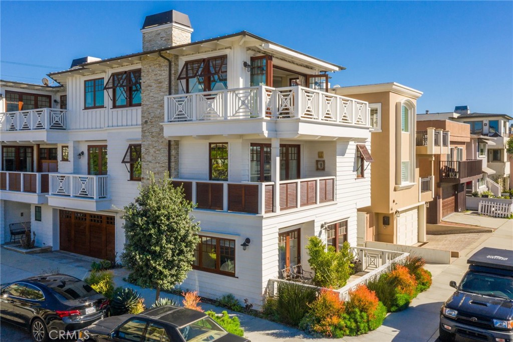 Immerse Yourself in Coastal Tranquility. Evoking the timeless elegance of a bygone era, this meticulously crafted, ocean-view townhome has 4 bedrooms, with en suite baths. This exquisite townhome is a rare gem and just steps from the sun-drenched beach and an easy walk to downtown restaurants, shops and the pier. The highly customized interior exudes comfort and charm, offering a sophisticated haven for the discerning homeowner who values both meticulous design and effortless California living. Wire-brushed wood flooring flows seamlessly throughout, creating a warm and inviting ambiance. All baths feature hand selected stone counters with porcelain tile floors, showers, and wall treatments. Enjoy the state-of-the-art sound system throughout, providing your desired ambiance wherever you go. Ascend to the top 3rd level via stairs or elevator, where the expansive great room unfolds. Bathed in sunlight streaming through expansive windows and an ocean-facing wall of unfolding doors. This haven boasts elegant tongue & groove ceilings and a custom-designed river stone fireplace. Motorized window coverings ensure effortless control over light and privacy. Step outside onto the spacious patio. Extend your culinary expertise with the impressive outdoor cooking center. Indulge in seamless indoor-outdoor living with the electrically retractable canopy transforming the upper balcony into an outdoor shaded oasis. Unleash your inner chef with top-of-the-line GE Monogram stainless steel appliances, including a dual oven range with six burners and grill, plus an additional large built-in oven, a built-in microwave, two dishwashers for effortless cleanup, a walk-in pantry and wine cooler to insure your favorite vintages are always on hand. The huge, hand-selected stone island is perfect for guests and family to gather around and for you to display your gorgeous creations. Each of the four bedrooms is a haven of tranquility. The spacious primary bedroom includes a custom-designed fireplace, large walk-in closet, electronic window shades, and a sunny west-facing balcony. Two other bedrooms have either a balcony or patio. This is more than a residence; it's a life style. Don't miss your chance to own a piece of paradise and step into a world of refined coastal living. Check out the attached virtual tour.