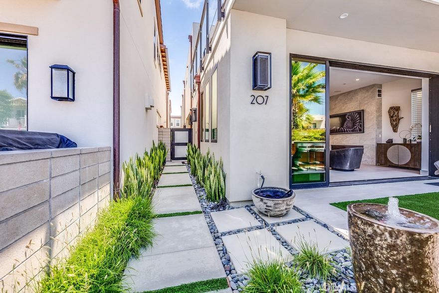 Welcome to Ocean Place, the ultimate beachside lifestyle offering in Seal Beach. This newly built (2020) residence offers an array of impressive upgrades that combine luxury, convenience, and ocean views. Situated in a desirable location on 1st Street, this home offers an unparalleled living experience with a truly open floor plan spanning nearly 3,400 square feet, including a primary suite with a custom-designed walk-in closet and a bathroom reminiscent of a high-end spa. Enjoy ocean views from your own balcony. Additionally, you’ll appreciate two generous secondary bedrooms with private baths, a large second-level loft/media space, and a third-level rooftop deck perfect for enjoying daily sunsets while dining and entertaining under the sun. Notable upgrades include remote-controlled Hunter Douglas shades, providing both style and privacy, custom landscaping with an outdoor patio, a built-in Lion barbecue area, bar-style seating, a whole-home security system, built-in Sonos sound, and a chef’s-inspired kitchen equipped with professional-grade Subzero and Wolf appliances. Indoor and outdoor spaces seamlessly meet via Nana Wall bi-fold doors, creating a blend of nature and contemporary living. Indulge in the outdoor shower and watch as daylight transitions to dusk, while timed exterior lighting accentuates the home's architectural features in the best way. Modern conveniences continue with a tankless water heater, a spacious 2-car garage equipped with 240-volt electric, an unrivaled locale, and a two-minute walk to the sand. 207 1st Street is the exemplary display of coastal living at its finest.