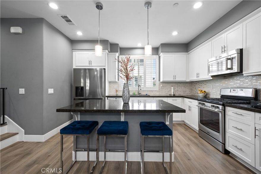 Welcome to luxury living in the gated Nexus community of Eastvale! This luxurious 4-bedroom, 3.5-bath, 3-story condo has been recently remodeled and features a unique floor plan. Upgrades include new flooring, kitchen backsplash, countertops, shutters, and fresh paint. Enjoy your private balcony and the benefits of a low HOA. Conveniently located near shops, a gym, grocery stores, and Interstate 15. Community amenities include a playground and pool. Experience the perfect blend of elegance and convenience in this stunning Eastvale condo!