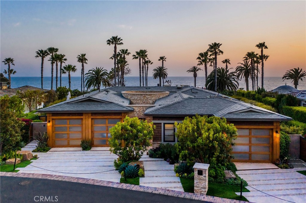 Welcome to this beachside masterpiece, offering a prime location in the coveted front row of the ultra-exclusive Montage Ocean Estates. Enjoy stunning panoramic views of the ocean and epic sunsets from nearly every room in this vast, open-concept estate. Through the intricately-detailed walkway, a custom rotunda entry sets the tone for the palatial residence within. Each and every design, material, and finish has been hand-selected with inspiration from global influences, including the custom ocean-inspired mahogany ceilings in the living room, exquisite onyx kitchen countertops, custom wood-set walls, abalone shell inlays, and the interior design curated by award-winning Ziccardi Designs. Disappearing walls of glass open to reveal the top-end finishes and features characterizing the garden-like outdoor spaces, such as a Pebble Tec infinity-edge pool, custom outdoor fireplace, BBQ area, wet bar, and a separate Zen garden with custom waterfalls and rock features. Among the countless additional amenities of this opulent estate are a climate-controlled 1,000-bottle wine room, workout area with a custom glass ceiling, radiant heated floors, ELAN smart home system, a custom artistic stairwell, a truly tranquil spa-inspired master bathroom, and a home theater with a custom 9-screen TV set. To top off this truly once-in-a-lifetime opportunity, enjoy unparalleled access to the 5-star resort amenities of the prestigious Montage Laguna Beach in the privacy and comfort of your own home.