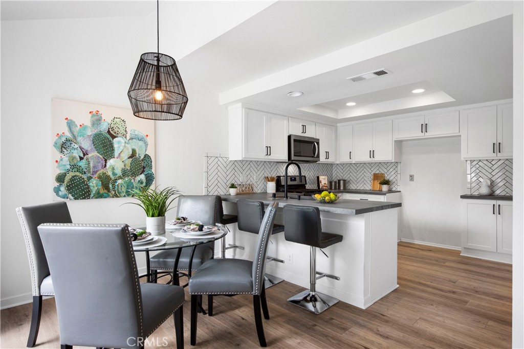 You are going to love how open and bright this super cute remodeled upper level condo. No one above or below you! When you walk up the staircase you will find a quaint patio, a perfect place to relax and unwind. The over sized living room with its soaring ceilings and abundance of natural light offers a bright and open space. Living room offers extra space for a home office if needed. The kitchen has been beautifully remodeled with Caesar stone counter tops, stainless appliances, white cabinetry, stainless deep sink, custom back splash and recessed lighting. Dining space offers room for table and chairs with added counter seating. Stackable washer and dryer is conveniently located off the kitchen. One bedroom is on the main level with plenty of space for a king size bed and a large closet space. The attached bath was recently remodeled with quartz counters, walk-in shower and designer selected finishes. On the upper level you will find a private spacious master bedroom that is light and airy with a wall of mirrored closets. The attached bath was also perfectly remodeled with the finest of finishes. Additional upgrades include brand new vinyl plank floors in the perfect shade, hi-end designer selected carpet on stairs, premium window coverings, fresh paint and so much more. A coveted detached one car garage and endless additional parking close by, makes this a great place to live. Community offers pool, two spas, tennis courts, barbecue area and HOA pays for trash and water. Shopping and dining is on every corner and award-winning schools! Several parks and trails are in close proximity, easy access to 73 Toll roads, freeways and just minutes away from the most beautiful beaches! Low taxes with no Mello Roos.