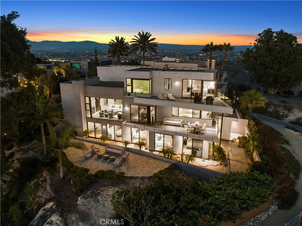 " Eagles Nest" An architectural masterpiece, located on one of the most coveted stretches of coastline , an epic joining of land and sea years in the making, the vision and design of renowned Laguna Beach Architect Mark Singer .The seamless, timeless and flawless design captures 270 degree views of iconic Laguna Beach , awaiting the most discerning clientele. The ultimate in modern coastal living awaits at this masterpiece , where sophistication, design and high-end finishes meet to capture mesmerizing views and natural light throughout the homes floor to ceiling glass windows, high ceilings, decks throughout and skylights. The modern residence exquisitely encapsulates unique designs , crisp angles and impressive fixtures, Massive floor to ceiling glass and decks to enjoy panoramic ocean, Catalina , canyon, city, shoreline and sunset views. Enjoy breathtaking breezes while entertaining family in the open living room with fireplace and sleek kitchen , well appointed island , custom cabinetry and high-end appliances. 5523 sf of living space that affords views from EVERY room, the 5-bed plus media room, plus game room 5.5 bath design is served by an ocean-view glass elevator and two artistically designed floating staircases, custom lighting, floor-to-ceiling windows, a smart-home automation system. The resort like master suite is appointed with a large deck to the ocean , walk in closet, fireplace, free standing tub facing the pacific and plenty of glass to take in the beauty of the coastline. A media room , office, 4-car garage and gated enclave of 6 homes are additional highlights that complete this stunning property. Outdoor Zen-like spaces encompass the uniqueness of this home and its prime location that’s away from it all, but close to everything, including hiking trails, beaches and the Laguna Beach Village. The property is undergoing an extensive revitalization keeping true to Mark Singers vision for this site. The Rare opportunity to own this trophy property awaits.