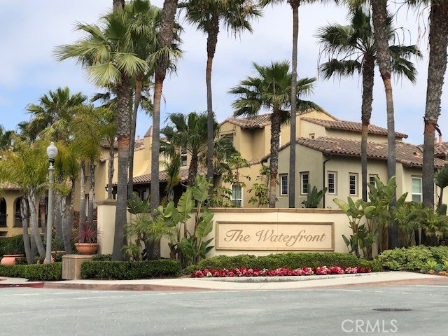 Resort style living across from the beach!!! Newer, quiet community at "The Waterfront" behind the Hyatt Hotel and steps to upscale shopping and dining at "Pacific City" and the ocean. 2 Bedrooms, 2 1/2 bath of luxurious living in the gated community that offers pool, spa and BBQ area. 2 car attached garage and inside laundry room with washer and dryer. Each bedroom with their own bath. Beautiful hard wood flooring, Living Roon and Dining Room with fireplace and balcony overlooking lovely courtyard area with peaceful water features. Chef's kitchen with B/I stainless appliances, granite and stone surfaces and lovely office nook off the kitchen. Spacious Master Bedroom suite with beautiful bath with stone shower, soak tub and large walk-in closet with gorgeous wood built ins. This is a gorgeous home!