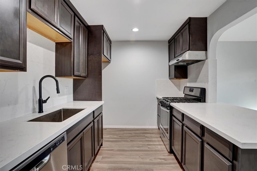 Beautiful remodeled condo in the gated Villa Warner community! Lots of upgrades in the past year including a new kitchen, updated bathroom, newer flooring, newer windows, and recessed lighting. This ground-floor residence faces south and has a spacious sunny patio. One covered assigned parking space and the HOA includes water, gas and trash. Excellent location close to the beach, shopping, dining and parks. Lovely community pool, spa, barbeques and a clubhouse.