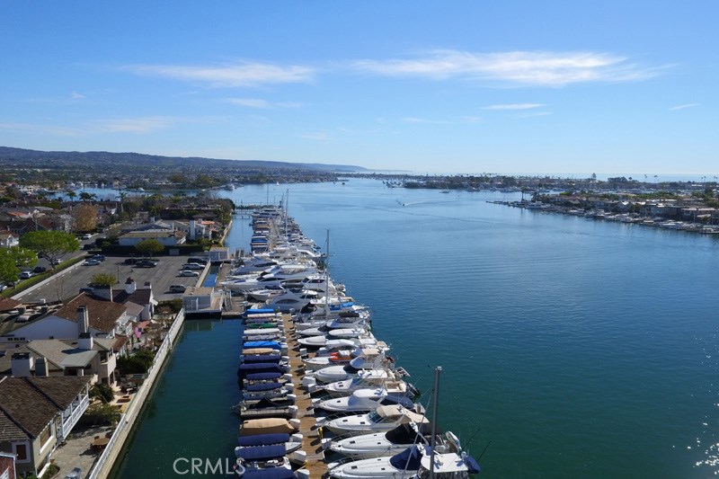 Have "front row seats" to all of the activity of Newport Harbor from this ultra-luxurious soft-Contemporary Bayshores bayfront home. From this “best of the best” waterfront locations you can view the morning crew workouts, daily glorious sunsets, the never-ending boat activity of the Lido Channel and Main Turning Basin including sailboat races, paddleboarders, and the spectacular Christmas and 4th of July boat parades. Located four houses from the Bayshores beach and the private gate to the world famous Balboa Bay Club, this 2006 built home is a compilation of the skills and talents of architect, Sydney Head and designer, Wendy Young. Designed for stylish indoor outdoor living, the home has a wall of retracting glass doors that seamlessly blends the huge waterfront patio, with its outside spa, fire pit and bbq area, with its bayside great room. The home features a waterfront great room with a fireplace, an elevator, a large island kitchen with professional grade appliances and a waterfront dining nook; a media room, formal dining area, mud room, powder bath, a private bedroom suite and a three car attached garage. The upstairs of the home features a luxurious waterfront master suite with a marble bath and a huge walk-in closet and three additional bedrooms with en-suite baths. Bayshores is a gated community of 249 properties on the shores of Newport Harbor that features two private beaches, spectacular turning basin views, a private large yacht marina, and a children’s park.