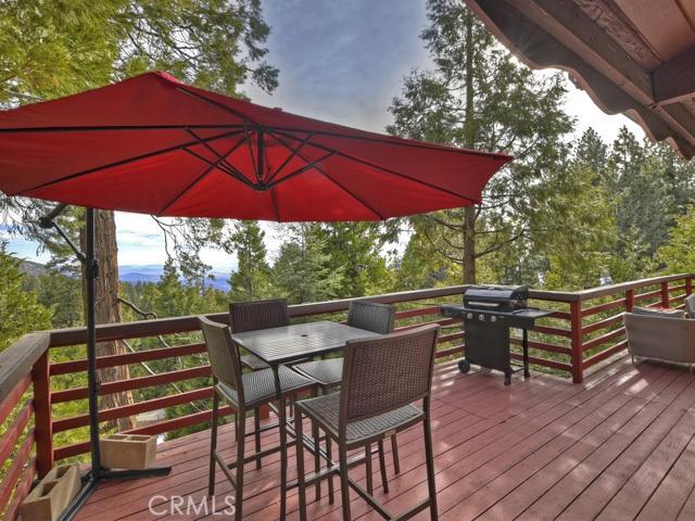 Enjoy stunning mountain vistas and city lights views while relaxing on the private deck of this updated mountain home. This hard to find 1 level home features 2 bedrooms, 1 bath with an open floorplan perfect for entertaining family or friends. Home is tastefully decorated has newer flooring and updated light fixtures throughout. Kitchen has convenient breakfast bar and stainless appliances. Laundry is located in large build up space which could be perfect for potential future expansion of living space. Home is ideally located close to town, ski slopes, Skypark at Santa's Village, and Hwy 330 for commuting. Don't miss out!