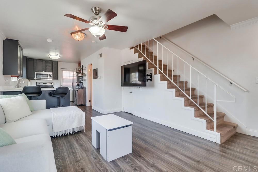 This beautiful ground level end unit is truly a gem within its well-maintained complex. With a gated entrance providing security and peace of mind, this property offers a heightened sense of privacy and exclusivity. The interior boasts a modern appeal with new wood laminate flooring, carpets in the bedrooms and on the stairs. The kitchen is a standout feature, showcasing newer cabinets and granite countertops, along with stainless steel appliances that add a touch of sophistication. The thoughtful inclusion of ceiling fans in the living room and bedrooms ensures comfort and energy efficiency. This unit comes with a new in-unit washer and dryer. In addition, the property offers two parking spaces for your vehicles. With low homeowner association (HOA) fees, this home offers an exceptional value and a high-quality living experience.