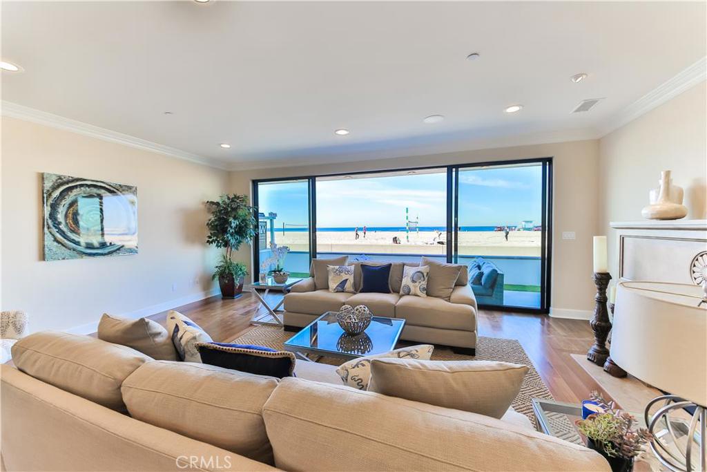 NEW LUXURIOUS OCEAN FRONT HOME with over 5000 square feet and 800+ square feet of ocean view patios and decks - Walk a few feet to the sand, surf and volleyball courts - The home is very unique because of the subterranean area which includes a media area, game area and large complete lounge/bar area with sink, 2 refrigerators, wine cooler, freezer, ice maker and granite counter top which can seat 4 plus guests - It also has direct access from the beach to a nice size patio area with a shower to rinse off - This access also offers natural light to the downstairs and is one of only a handful of Strand properties that offer this feature and extra square footage - First level offers a 2 car garage + guest parking, kitchen with 6 burner Viking Stove and Sub Zero refrigeration, dining area, living room with fireplace - Second level has a ocean view Master suite with deck, 2 more bedrooms with baths and a large laundry room - Third level has a "Widows Watch" with large ocean view deck, sink, microwave, refrigerator and ice maker to entertain friends - There are two more bedrooms and bathrooms plus custom Mahogany Raised Paneled Office/Library - There are Brazilian Teak Floors and Honduras Mahogany Cabinets and doors