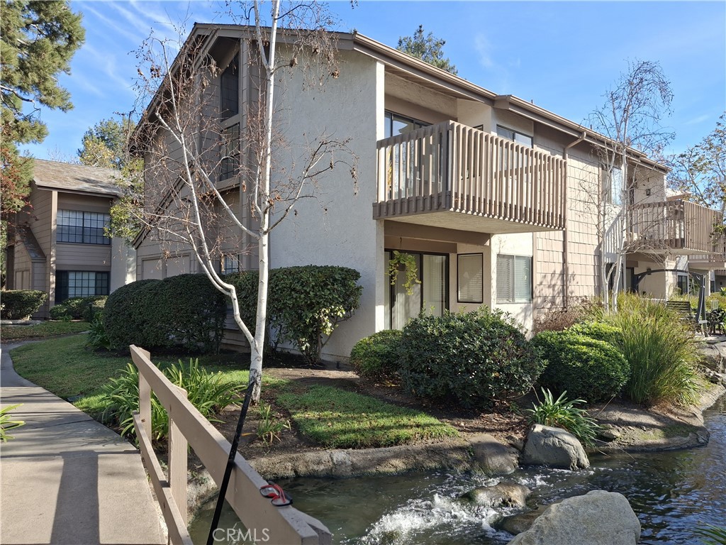 This charming end-unit condo, situated on the upper level, offers a private patio overlooking a tranquil man-made brook and pond, surrounded by lush, mature trees. The light-filled interior features soaring cathedral ceilings, new paint, kitchen and appliances, a cozy living room with direct access to the patio. The dining area includes mirrored accents, and the spacious one-bedroom layout boasts a walk-in closet and in-unit laundry for added convenience. Located in the desirable Quail Creek complex, residents enjoy access to pools, spas, tennis courts, a dog park, scenic streams, ponds, and beautifully maintained greenbelts. The HOA dues cover water, trash, sewer, gas, and insurance; the tenant is only responsible for electricity. The unit includes covered parking (Space #800). Easy access to freeways, restaurants, and shopping makes this a perfect place to call home!