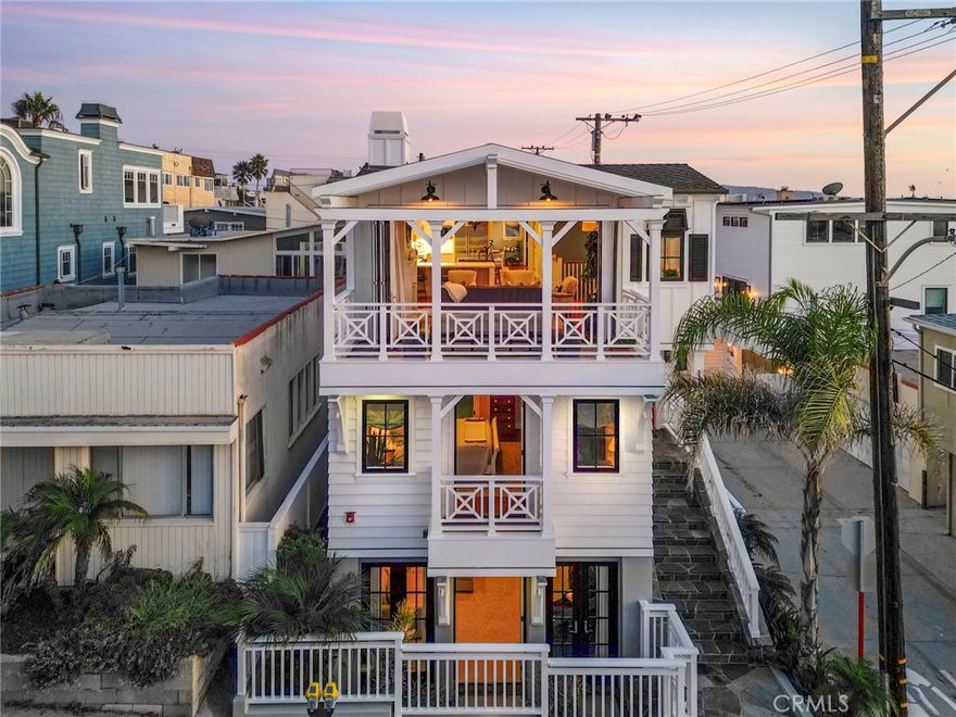 Wake up to the sounds and salt air of the ocean flowing in through the linen drapes of your balcony, the day full of possibilities. The water glistens out your west-facing living room windows and a paddle boarder passes by as you enjoy your morning coffee. The warm, walnut floors feel soothing underfoot as the morning sun pours in from the skylights overhead. Quality of craftsmanship delivers fulfillment everywhere you look. Expansive built-ins, plentiful storage closets, marble countertops, fine millwork along with designer lighting, tiling and fixturing enchant the eye. Vaulted, beamed tongue-and-groove ceilings soar upward mimicking the expansive coastal horizon awaiting outside. Loved ones come and go as the day passes. Plenty of beds and baths for everyone to gather in comfort with ample parking for rides and toys. Coming off the beach, no invitation is needed to lounge and linger down in the beach room after showering off in the privacy of the enclosed hot-water outdoor shower.  Grab a beverage out of the bar and cool off barefoot on the smartly tiled floors enjoying the breezes and mature, lush plantings through the triple-set French doors. As you head upstairs, just when it seems impossible that life could get any better, you see the sun begin its unspeakably magical descent over the Pacific Ocean outside your home, radiating pink and orange hues over the waves. Two sets of folding doors open at opposite ends of the living room level allowing a seamless flow from the outdoor panacea to indoor sanctuary, where everyone congregates to admire Mother Nature, share the day’s adventures and take part in the BBQ. Tucked away on a quiet block between Manhattan and Hermosa Avenues, 7 miles from LAX, this prized and rare 100 block of North Hermosa Beach is a beach lover’s dream awaiting your arrival.