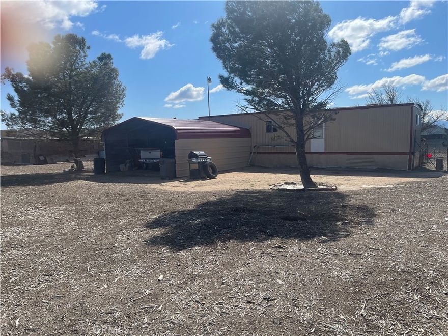 10 acres with mobile home all utilities 2-bedroom 1 bath, level lot on a WATER WELL, enclosed patio approx. 650 sq ft carport 2 cars grown pine trees. Street name is Calle De Amistad per county is Colusa