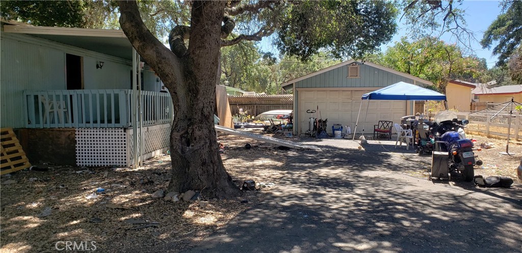 3 bedroom 2 bath with detached 2 car garage all on a large fenced lot under the canopy of mature oak trees. The surrounding road was upgraded for ease of access. Home has a galley style kitchen, generously sized living room, dining area, 2 guestrooms, guest bath, and large primary bed and bath. Front and back deck to expand the living area. Tenants would like to stay.