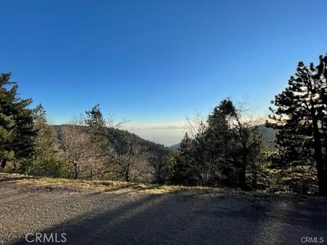 Large Road Frontage Lot, with **Breathtaking Unobstructed Views!!!** Amazing Property to Build your Dream Home on with 121 feet of Frontage! Nestled in a Neighborhood Overlooking the Inland Empire. Paved Road, Upslope Lot with Beautiful Boulders that can be incorporated into your building plans. Check with Lindel Cedar Homes to see what they have to offer! Two Red Posts in front of the property are approximately at the eastern corner & the lot runs west. Peaceful and Serene Community. Don't Miss Out on this Amazing Opportunity!