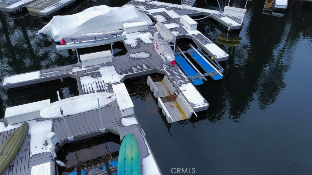 Beautiful dock in excellent condition located in the deeper water area of Meadow Bay. First multiple where bay opens to the lake makes for calmer waters and a quick boat trip to the village restaurants, shops and concerts. Easy access from the water into herringbone style slip and special feature on this slip, hydro hoist and generator to preserve your boat out of the water while not in use. Easy access to the dock from stairs at marker 36 (turn right on lake trail) or stairs at marker 35 (turn left on lake trail). Nearby restroom at lake trail is a really convenient feature - especially if you have little ones visiting! Shoreline is set amongst the pines for a peaceful lake sanctuary. Parking on North Bay road is between markers 35 & 36.