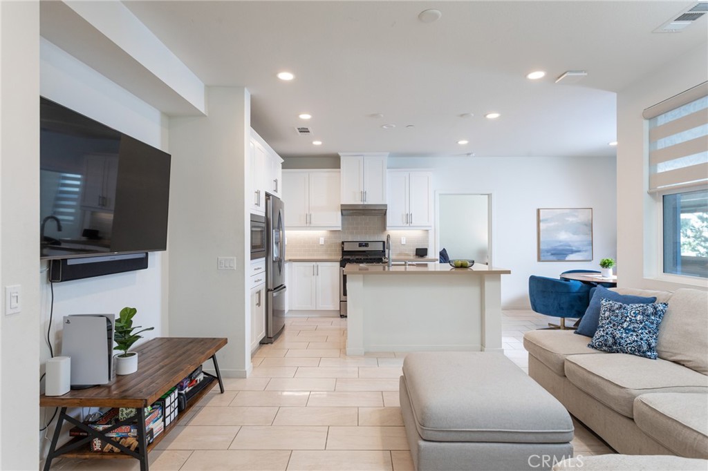 Completed in 2019, this modern, move-in ready flat has it all! The perfect location in Nova, a community of Irvine’s vibrant Great Park neighborhood. Sophisticated style, quality materials, and numerous upgrades including ClareHome remote automation, Sonos and full surround sound. The desirable floor plan by Taylor Morrison Homes has 2 bedrooms and 2 full baths, in-unit stacked Whirlpool laundry, and open-concept living areas that open to a private outdoor balcony. In this great-room layout, living space blends seamlessly with the eat-in dining area and kitchen, and large windows pour sunlight onto light, beach-wood style floors and wide-format tile. The chef’s kitchen features a breakfast-bar center island great for cocktails and casual dining, immaculate quartz countertops, shaker cabinets, and quality stainless-steel appliances. When the day is done, retreat to your primary suite with a spa-quality, private en-suite bath, double sinks and large shower stall. Each full bathroom is outfitted with shaker vanities and contemporary finishes. In this exceptional location, everything is conveniently nearby! Within the Nova community, just a short stroll away, enjoy multiple parks and dog parks, a resort-style pool, spa and clubhouse, and a neighborhood coffee shop. Within minutes, explore shops and local dining, hop on the freeway for easy commutes, and indulge in endless Great Park recreation. Looks, location, amenities - this one checks all the boxes!