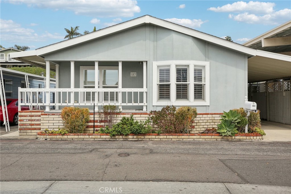 Embrace the beach city lifestyle in this exceptional coastal home, just one mile from the beach. This 1,638 sq. ft. manufactured home in the Huntington Shorecliffs community features two bedrooms, plus a den/office that can be converted back into a third bedroom, and 1.75 baths. Located in a prime area of the community, you'll have easy access to numerous amenities, including two clubhouses, two pool areas, a fitness center, game room, and a pedestrian beach walkway. The home boasts a spacious living room, formal dining room, vaulted ceilings, and dark-wood laminate floors throughout. Enjoy plantation shutters, recessed lighting, and a laundry/utility room with a pantry and included washer and dryer. The kitchen offers ample cabinet space, a center island, a breakfast area, a separate entry door, and appliances including a dishwasher, refrigerator, oven, and microwave. The master bedroom features a large walk-in closet and an en-suite bathroom with dual sinks. Outside, the backyard provides a perfect space for relaxing and entertaining, with no neighbors directly behind. Additional features include an expansive storage shed and a covered carport that accommodates two cars. Live just steps away from the coast in this outstanding home!