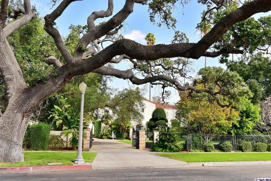 Gated estate on coveted Lombardy Road! This 1925 Spanish Colonial Revival home of approximately 7,000 square feet on close to an acre of striking grounds features a 6 bedroom, 6 bath home, pool and spa, separate guest quarters over the two car garage, expansive lawns, covered arcade with arches and columns, large koi pond, a regulation size north/south tennis court with newer US Open spec surface, and mature trees and landscaping. Other features include an impressive foyer, formal living room with fireplace, grand formal dining room, butler's pantry, kitchen opening to the spacious family room, and library with fireplace. There are 2 bedrooms with baths downstairs and 4 bedrooms upstairs all with balconies capturing views of the San Gabriel mountains and gorgeous stately grounds. The maste