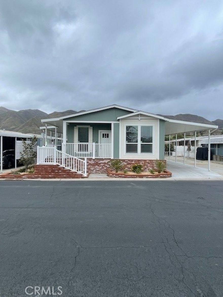 1 year FREE space rent!....Located in a desirable 55+ community, you don’t want to miss out on this BRAND NEW three bedroom, two bath home. This beautiful home comes included with brand new stove, microwave, refrigerator, dishwasher, farmhouse style sink and a large island for entertaining guest. Enjoy the breathtaking view of the San Jacinto mountains while entertaining on the wrap around porch & patio with an extra shed for ample storage and added privacy.