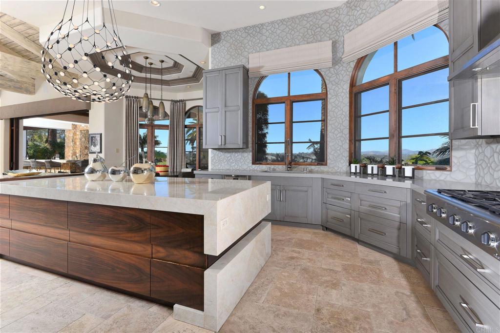 Captivating and uncompromised golf course and mountain views, this impressively renovated single-level estate on over 1.5 acres offers a refined style with unmatched quality craftsmanship and high-end finishes. Conveniently located inside the gates of the esteemed community of Rancho Pacifica, this property is unlike any other with custom designer details incorporated throughout. Offering 5 large bedroom suites, contemporary kitchen, temperature-controlled wine cellar tasting room, executive office, home theatre, and billiards/game room. Large disappearing walls of glass seamlessly transition between indoor and outdoor living spaces, ideal for both large scale entertaining or more intimate gatherings while taking advantage of pleasant southern California weather year-round. Outdoor living at its finest; living room with fireplace overlooking the vanishing edge pool/spa/water features, plus fireplace and BBQ kitchen, putting green, garden, and fire pit. An oversized 5-car garage for the car enthusiasts plus workstations and ample storage. An exceedingly rare find, this exceptionally private property is located just minutes from North County’s best beaches, golf courses, restaurants, shops, the Del Mar racetrack, and more.