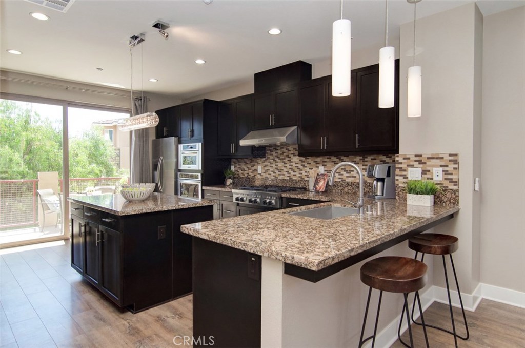 Rare opportunity to lease this newly built in 2014, stylish, urban home on a prime corner location with excellent frontage, view, and privacy all around. This upscale home is adorned with wide plank laminate floors that flow seamlessly throughout all 3 levels. The second level is comprised of the kitchen, great room, dining room, bedroom & bathroom, balcony, and laundry area. Dark shaker cabinetry with granite countertops, subway tile backsplash, island & breakfast bar, and commercial grade, stainless steel Kitchen Aid appliances create a kitchen that’s refreshing and modern. The great room boasts high ceilings, high windows and 2 luxe ceiling fans. The private master suite occupies the entire third level boasting a balcony with fantastic views, sleek barn door leading to bathroom, spacious walk-in shower, & walk-in closet with mirror door. Fantastic community amenities offer newly remodeled Vantis Clubhouse with swimming pool, cabanas, outdoor fireplace and BBQ’s, fitness center, & more. City Walk is conveniently located within walking distance to the Aliso Viejo Town Center with shopping, restaurants, theater, and easy access to the toll road. Run, don’t walk, to City Walk, a perfect blend of professional ambitions with personal needs.
