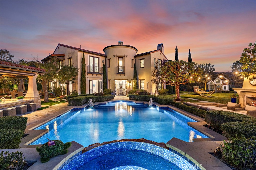 Positioned at the highest point in the prestigious guard-gated community of The Summit at Turtle Ridge, this extraordinary custom estate offers breathtaking panoramic views of the ocean, Catalina Island, city lights and the mountains. Ideally located at the end of a quiet cul-de-sac on a premium, private corner lot this estate combines elegance, comfort, and functionality in a setting of unparalleled beauty.
Spanning over 6,000 square feet of thoughtfully designed living space, this home features: grand living spaces: a welcoming entry foyer, formal dining and living rooms, bonus room with built-in bar for entertaining, office, gym, upstairs TV lounge area, and a playroom.
The Gourmet Kitchen Equipped with a massive granite island, a 6-burner stove with pot filler, Sub-Zero refrigerator, walk-in pantry, and butler’s pantry. Kitchen opens to breakfast nook and cozy sunroom with fireplace.
The primary suite retreat is a luxurious sanctuary with breathtaking views, a sitting area with fireplace, luxurious bathroom, and perfectly designed walk-in closet.
3 additional bedrooms located upstairs and 1 downstairs, all feature walk-in closets, and private bathrooms for ultimate convenience.
With over 16,000 square feet of resort-style outdoor living meticulously designed and landscaped backyard is an entertainer’s dream. With a saltwater pool and spa, a one-of-a-kind outdoor bar featuring five flat-screen TVs, two fireplaces, a full outdoor bathroom with shower, and a custom playhouse.
The Summit at Turtle Ridge offers an array of world-class amenities, including two resort-style pools, a spa, gym, playgrounds, a clubhouse, a theater, and scenic hiking trails. Additionally, this home is within short distance of award-winning Vista Verde Elementary/Middle School and University High School.
With spectacular panoramic views and sumptuous features, this home offers a lifestyle of unmatched luxury and comfort. Don’t miss the opportunity to make this extraordinary estate your own!