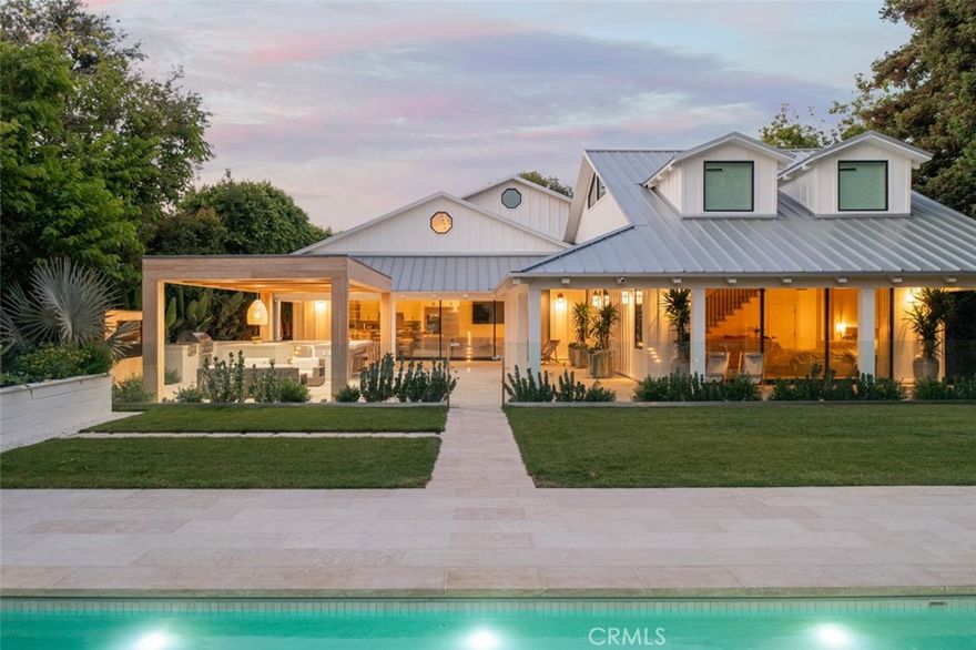 Welcome to 2419 Santiago, a stunning contemporary modern home that exudes sophistication and elegance. This exceptional property has been meticulously crafted to the highest standards, offering a seamless blend of sleek design and functional living spaces. Just beyond two sets of private and motarized gates, this impressive residence encompasses five generous bedrooms, four and a half bathrooms, and sits on over half an acre of land, offering ample space and privacy for your family's comfort and enjoyment. Prepare to be captivated by the perfect harmony of minimalist aesthetics and efficient space utilization. First impressions won’t be the last thanks to a foyer with clerestory windows and a fireplace-warmed living room that opens to a set of two classic porch swings out front. The space is enhanced by its pristine white walls, expansive wide-plank white-oak flooring, skylights, and soaring vaulted open-beam ceilings, collectively cultivating an atmosphere of spaciousness and lightness. The home’s great room is where it’s at, with access to both the backyard through slide-away glass doors, and the kitchen, which presents a massive island with seating, marble countertops, tile backsplash, Shaker cabinetry, built-in refrigerator with glass doors, and a Wolf range. Covering two levels, your primary suite is large and private, complete with a loft, wraparound patio, walk-in closet, and a swank new bath with freestanding tub and a walk-in shower. Interiors reflect the talents of Newport Beach-based design studio Prairie Interiors. Outdoors, Garden Studio Design of Corona del Mar has turned a half-acre-plus homesite into a private paradise with a pool and spa, raised sundecks, lawns, and a party pavilion with bar seating, built-in heaters and more. A metal roof, board-and-batten siding, dormer windows and a three-car garage with custom doors grace the exterior. Back Bay play is just a few blocks from home, and top schools, great parks, shopping and dining attractions, beaches and Orange County’s airport are moments away.