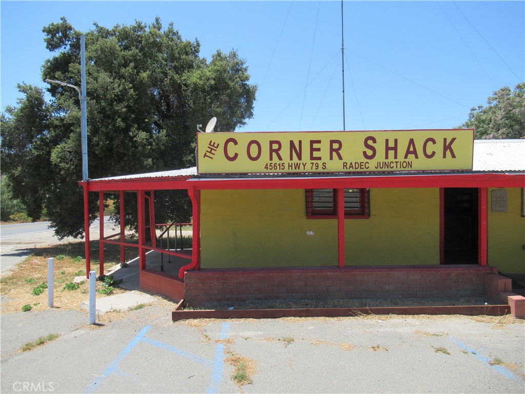 Fantastic investment opportunity. Corner Commerical lot located on Hwy. 79. Main building has a large open retail space with additional utility rooms, kitchen, two bathrooms and manager quarters. Additionally, this property offers a large, detached garage / workshop. There is also a covered enclosed trailer on the property for additional living space. Located on a 1.67-acre lot. All waiting for your creative vision and some elbow grease.