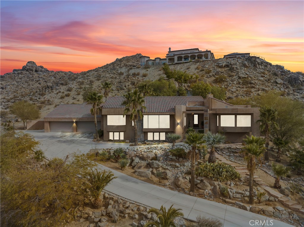 APPLE VALLEY - ESCAPE TO DESERT MODERN LUXURY. Experience the epitome of desert living in this breathtaking 4,000 SF M/L one of a kind Home. Designed for both elegant entertaining and comfortable family living, this exceptional home offers a seamless blend of sophisticated style and the tranquility of the surrounding landscape. Step inside and be captivated by grand living spaces. A formal living room boasts a focal point fireplace and oversized windows framing panoramic views. The adjacent formal dining room provides an elegant space for gatherings. Unleash your inner chef in the gourmet kitchen; custom cabinets; storage, and top-of-the line Viking appliances. The Breakfast nook offers a cozy spot for morning coffee. Relax and recharge in the family room, anchored by a warm wood-burning stove. Retreat to the expansive master bedroom suite, complete with a large spa-like bath featuring a separate shower and his-and-hers custom walk in closets. Large laundry room with storage. Two additional bedrooms on the lower level with an en-suite bath, provide ample space for family and guests. Step outside, just off the family room, to your own private oasis, featuring a sparkling pool and cascading waterfall. A wind and sun-protected covered patio provides the perfect setting for outdoor dining and entertaining year-round. A four car, oversized garage, with additional loft storage is a plus! This exceptional home is ideally situated for easy access to freeway connections. Enjoy the convenience of nearby shopping, dining and entertainment options. Also close by to the hospital and other medical facilities. With its prime location, upgrades and one-of-a kind views, this Home is exceptional. Don't miss this rare opportunity to own a piece of desert paradise!