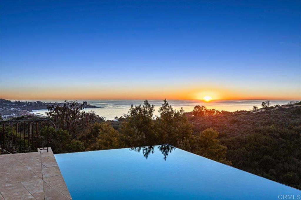 Timeless design seamlessly blends with the surrounding environment to create the perfect contemporary estate. Designed by Island Architects, the 4BR home combines angles and light to enhance the property’s VIEWS from every room with steel glass windows, overlooking beautiful ocean, mountain and La Jolla Cove views, privacy, in-ground pool, at-home sauna, wine cellar and outdoor living area. Walls of glass windows create a sense of light and openness throughout the home, complete with an open chef’s kitchen, master suite with sweeping views, media room, Lutron Lighting, surround sound speakers, custom hydraulic elevator system by Cemcolift and Somfy Remote Controlled Draperies and Durasol Awning Solar Window Screens.