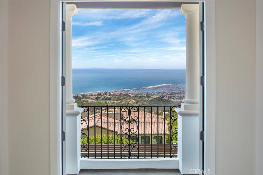 Centrally located and perched at the pinnacle of Ocean Heights, this 100% newly updated estate embodies the pursuit of perfection and luxury living in the prestigious Newport Coast community. Enjoy the very best views in Newport Coast with panoramic unobstructed views of the Pacific Ocean, Catalina Island, Newport Harbor, And city lights all the way to Los Angeles. This meticulously crafted residence boasts exquisite finishes and modern amenities that redefine elegance and comfort. Step into grand living spaces adorned with custom Armani Bronze marble in the family and living rooms, seamlessly flowing into the sophisticated dining area. The gourmet kitchen features new Neolith countertops, all new Miele appliances, state of the Art Refrigerators and freezers from highly desired True Manufacturing, ideal for culinary enthusiasts who appreciate both style and functionality. The main floor master suite is a private sanctuary with attached master retreat/office, featuring Sahara Noir finishes, a steam shower, and Toto toilet with custom heated seats. Custom European closets offer ample storage, while the luxurious master bathroom is complemented by Restoration Hardware light fixtures and Rohl faucets. Attention to detail is evident throughout, with Emtek hardware door handles, custom European tile, and a new walnut staircase adding to the home’s refined aesthetic. The property is equipped with a state-of-the-art sound system and lit mirrors in the bathrooms. The home is equipped with a detached office and use the master retreat as a second office for the working couple. Outdoor living is equally impressive with a firepit and all new Neolith counters with new BBQ fit for entertaining, set against the backdrop of newly landscaped grounds. Fit with a three-car garage featuring Lift Master systems and a Tesla supercharger, catering to modern needs. Enjoy breathtaking views from the rear yard and living spaces, upper floor balconies, or unwind in the bonus room/game room. The home also includes an all-new laundry room, all new custom doors, and all-new European fireplaces, enhancing its appeal. This residence is not just a home; it’s a lifestyle. With its stunning wide open views, 100% remodel and central location, there is nothing like it on the market.