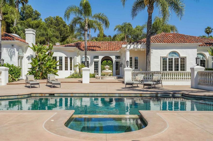 Set behind private gates within the gated community of Rancho La Cima, this remodeled single level traditional estate is comprised of over 7,600 square feet. With 7 beds and 7.5 baths, the property features an open floor plan including a seamless master suite offering separate dressing rooms and ample closet space with a spa-like bathroom. Floor-to-ceiling windows allow abundant natural light throughout the house. The expansive backyard is perfect for entertaining and promoting resort-style living with a heated pool and spa, tennis court, private seating, and more!