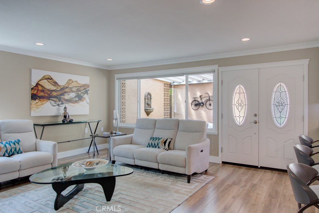 Highly sought after CORDOBA Model!! Spacious, Elegantly Remodeled, This End Unit is surrounded by a Beautiful Green-belt. Relaxing views of Beautiful Trees, plants and Grass. - No one Above or Below! Front Patio Gates Open to a Spacious, Private Outdoor Patio with a Water Fountain, Tile Floor, Ledger Stone planter and Entertainment Bar. Enter the Double Doors to a homey Open Floor Plan complete with an Entertainment Unit and Fireplace. The Kitchen boasts an Extra Large Island with a Breakfast Bar, All Quartz Counter Tops, All New Stainless Steel Appliances, convenient soft-close drawers and cabinets with roll-out trays. Dual Pane Windows, Central Heat and Air and New Stacking Washer/Dryer in the Hall Closet. In Addition to 2 bedrooms, this unit has a Large Office/Den/Game Room with 2 Skylights that bring in lots of Natural Light and a Barn Door to close the room off. Guest Bath with Glass enclosed Tub/Shower and Master Bath with large Walk-in Shower. Custom Lighting throughout this beauty! Owner may consider selling furniture. This unit is a Must See!