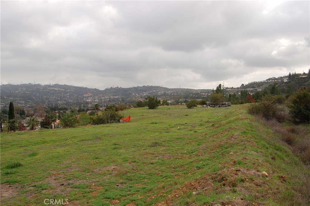 A magnificent 9.13 acres across 4 adjoining hillside view lots. Three of the lots may possibly be subdivided into 5 custom estates on one acre lots. The lots have been graded almost flat and the 1,876 foot retaining GEO WALL is 17+ years old and stands approximately 40 feet high! The GEO WALL runs almost perfectly East to West with fantastic views of the city, surrounding hills and views out to the mountains. Three of the parcels have the following acreage: Lot 20 which begins at Turnbull Canyon entrance is 4.291 acres; Lot 19 is located in the middle an is 1.85 acres; and Lot 18 is on the far west side at 2.986 acres. Lot 21 is a small parcel off to the left of the entrance that has only 240 square feet. Utilities are at the street, the main sewer line is in and mapped, the guardrail and driveway into the acreage has been permitted. This property is a prime property ready for a buyer/builder/developer.
