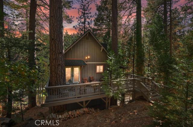 Whimsical Mountain get-away.. You'll be amazed at how wonderful this remodeled property is.. From the updated kitchen that opens to the dining and living areas with vaulted ceilings and wall of windows! Located on a nicely forested corner lot and featuring remodeled and updated kitchen plus all new Modern flooring (no carpet here), remodeled stacking-stone fireplace and 3 wonderful outdoor living spaces. Incredible Master with retreat bath featuring clawfoot tub and walk in shower. All dual-pane windows, A/C, tankless water heater, whole house automatic generator, window shutters and LED lighting. Office space and room for expansion ... This is absolutely a move-in condition property and is being offered incredibly furnished and decorated (less personals and some art, of course). Indoor laundry, plowed/maintained road, plenty of parking, public utilities and full Lake Rights.
