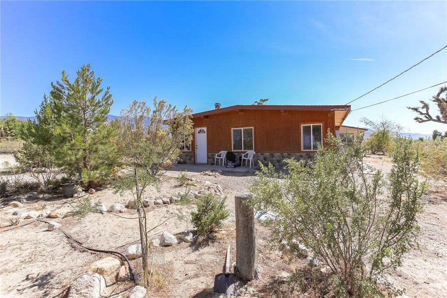 A true desert oasis and only 20 minutes to Big Bear! This spacious home in the Lucerne Valley is just the place for a peaceful retreat or a vacation rental. This home is on 2 1/2 fenced acres, and this serene location includes beautiful 360-degree views of the mountains with clear skies and clean air. There is an electric gate, ensuring your privacy. All of this, and you're still just minutes away from restaurants and shopping! The home has tile floors, new windows, beamed ceilings, and is made of cinderblock, so it's impervious to wood rot. The land itself can be divided if you wish to build, and it is ready for another water meter to be installed. The home is full of natural wood and is light and bright. The owner just put 4K into the septic system to have leach lines replaced and the tank emptied. There is also an irrigation system so that watering the beautiful trees on the property is a breeze. Another huge bonus is the attached apartment, perfect for renters or guests. The apartment is complete with a bedroom, full kitchen, and full bathroom. The home features stunning stonework and has a newer roof. Take a look at this tranquil home, where the sun shines all the time!