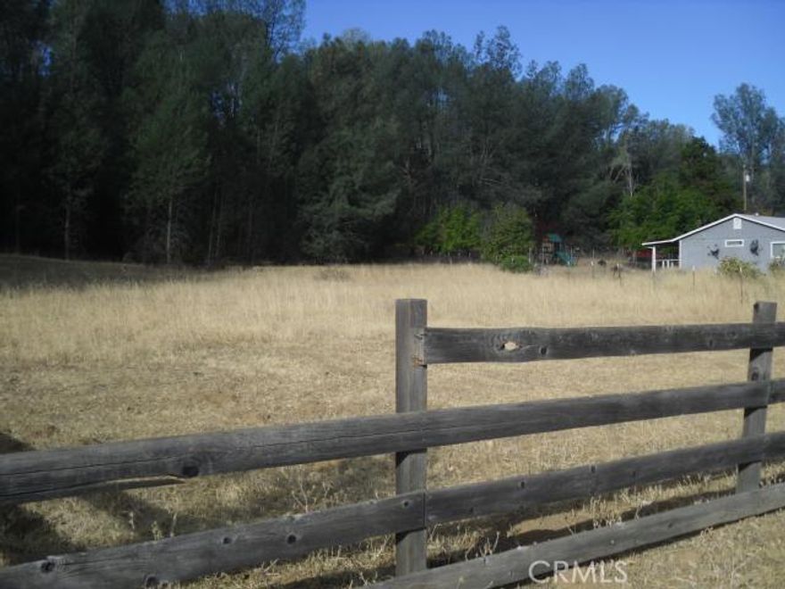 This wooded 1.68 acre parcel resembles an enchanted forest a possible refuge where one might meet up with mythical creatures.  A variety of trees on the property offer privacy, and may easily make for natural landscaping around the future home site.  Property is fenced so one can get an idea of where the future footprint of a building might reside.  Easy access, and paved road to property.  Water meter in place, and owner will carry - what is missing is you - the buyer.