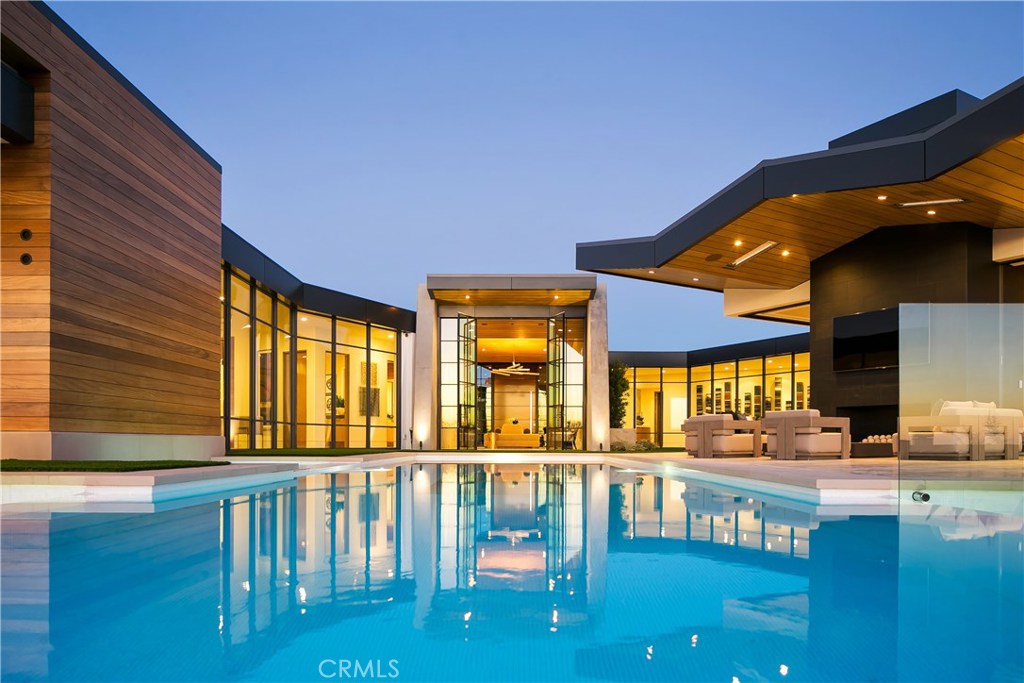 With an exquisite juxtaposition of raw and refined materials, this incredible estate was designed with exceptional materials, planning, detail & furnishings by Spinnaker Development. Spinnaker’s newest and most innovative build to date incorporates traditional architectural materials and form while introducing a contemporary open floor plan concept, pursuing maximum ocean views. Dramatic and expansive indoor / outdoor living elements and modern technology are blended with custom and imported detailing to create a truly unique coastal living experience, ideal for the prestigious Cameo Shores Community. The gorgeous kitchen features a top of the line Wolf and Sub Zero suite with two Bosch dishwashers, beautiful Lumix countertops & a fully functional butler’s kitchen. The master suite has custom made furnishings, including a pop up television cabinet, automated window treatments, his & her Toto washlets, round soaking tub, all slab steam shower, all with the Pacific Ocean as a backdrop. The dramatic entry includes a custom built twelve-foot mahogany door with hydraulic pivot and provides breathtaking views out to the mosaic glass tiled infinity edge pool with a glass bottom cantilevered over the living space below. The lower level has a dedicated movie theater with acoustic paneling and 137” screen, a great room for the sports enthusiast with 6 panel 4K media wall, oversized bar with all the amenities, walk in wine cellar, private grotto, as well as a private lower level suite.
