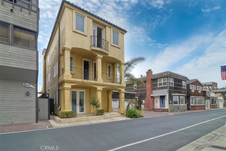 Mediterranean Style home with panoramic views of the Huntington Harbor and peek-a-boo views of the Pacific Ocean which can be enjoyed from many of the rooms in this beautiful three-level home. WALKING DISTANCE FROM SAND in the private, guard gated beach community of Surfside Colony! Many upgrades include extensive crown moldings, soaring 9' ceilings, 8' solid interior wood doors, French doors throughout, travertine flooring, gorgeous ornate iron stair rail leading up to every floor. Spacious kitchen features professional grade stainless steel appliances, custom cabinetry and granite counter tops. New paint and carpet throughout.  Two master suites—one with a fireplace and private balcony, another with stairs to a spacious sun deck. The detached 2 car garage offers a ROOF TOP DECK so you can enjoy the spectacular panoramic views.