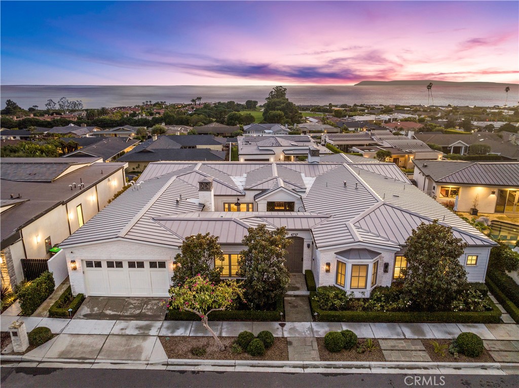 Step into a lifestyle that is nothing less than extraordinary in this Corona Del Mar. Sweeping ocean and Catalina views seamlessly blend with exquisite design, while a prestigious Cameo Highlands address places you perfectly on the map. Enjoy exclusive access to a private beach, top-rated schools, and all that makes CDM exceptional. Recently renovated by award-winning designer Jay Jeffers, the breathtaking aesthetics create an unmatched living experience in this single-level custom home spanning 4,493 s.f. +/-. with four bedrooms, a home office, and six bathrooms, featuring a neutral palette enhanced by bold pops of color. No detail is spared, from high-end hardware and stone surfaces to exquisite wallpaper, all crafting an atmosphere that sets this residence in a league of its own. A sun-drenched patio with fire pit runs the length of the house and looks out over ocean views and vibrant sunsets. Sliding doors whisk out of sight beckoning sunny vibes and salt air breezes into the living room, where reclaimed timber beams and a fireplace create warmth. The kitchen offers Thermador appliances, farmhouse sink, and a long row of marble countertops that stretch across ocean-view windowS. The dining room overlooks a private courtyard on one side, and the endless ocean on another, with a bar area that doubles as a butler's pantry. An adjoining temperature-controlled 800+ bottle wine room elevates every dining experience. Nestled in a private ocean-facing wing, the primary bedroom is a haven of tranquility where sunlight pours through sliding doors, highlighting a stone-trimmed fireplace. An exquisite bathroom offers a soaking tub, steam shower, and dual vanities, with dual walk-in closets boasting luxurious built-ins. A second wing hosts three guest rooms with ensuite baths, including a bunk room designed to capture little hearts. A private study creates a versatile space that offers the potential for a light-filled art or Pilates studio, with doors opening to a courtyard with a fireplace. A metal roof, wood flooring, hand-crafted millwork, custom built-ins, motorized window coverings, smart home technology, Lutron system, and a 3-car garage are details that exemplify meticulous attention to detail and quality. Residents of Cameo Highlands gain privatized beach access and are close to renowned golf courses, top-rated schools, the charming boutiques and eateries in CDM Village, Pelican Hill Resort, Crystal Cove State Park, and nearby Newport Beach.