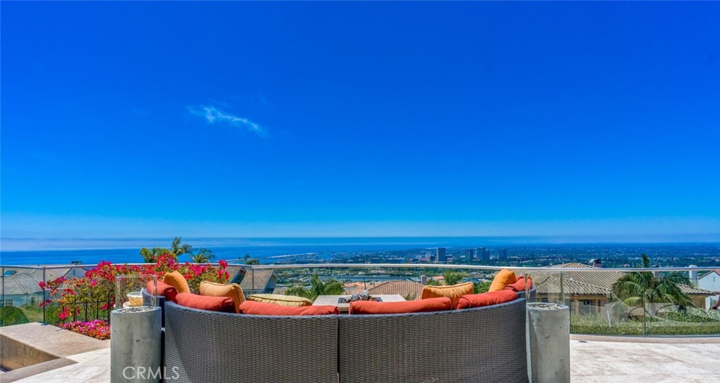 Arguably this custom Mediterranean Estate offers the absolute BEST VIEWS in all of Orange County. This architectural masterpiece is perched atop one of the most thought after community in Corona del Mar, Spyglass Hill. From the expansive ocean views to the twinkling city lights, this home offers endless 180 degrees unobstructed views. From the Ocean to Newport Harbor and the California coastline stretching all the way up to Palos Verdes, with year-round sunsets and Catalina Island resting in the backdrop you'll be able to experience the very best that Southern California has to offer from the comfort of your own home.
This custom residence has been fully rebuilt and expanded from the studs in 2006 with the highest quality materials, ensuring that you'll enjoy a lifestyle of luxury and sophistication that is second to none.
Sitting on a rare 13,500sq ft lot, you’ll benefit from a spacious driveway and one of the largest backyards in the entire community (over 80” wide). The outdoor living space is an entertainer's dream, with a custom-built pool and spa, built in outdoor BBQ area, and lush landscaping that is sure to impress.
This magnificent home spans over 6,826 square feet of luxurious living space, meticulously designed with the utmost attention to detail. Exotic African Walnut hardwood floors, Jerusalem Gold Honed Marble floors are just a few of the custom materials used throughout the entire home.
Upon entering, you will be captivated by the grandeur of the soaring ceilings, custom designed light fixtures, and an open concept living and dining area that seamlessly integrates indoor and outdoor living. The gourmet kitchen is a chef's dream, boasting top-of-the-line Viking Professional appliances, a spacious island, and ample cabinetry, perfect for entertaining guests or hosting intimate dinners with loved ones.
The master suite is an oasis of tranquility, featuring a private balcony that offers breathtaking views, two luxurious spa-like en-suite bathrooms (his and hers) that will satisfy even the most discerning fashionista. There are 3 additional bedrooms, each with its own en-suite providing comfort and privacy for family and guests.
This home also boasts a luxurious basement retreat, where every detail exudes sophistication and relaxation. Enjoy a game of pool, store your prized bottles in the award-winning wine cellar. With a large driveway, a three-car garage and Tesla charging, no detail has been overlooked in this magnificent residence.