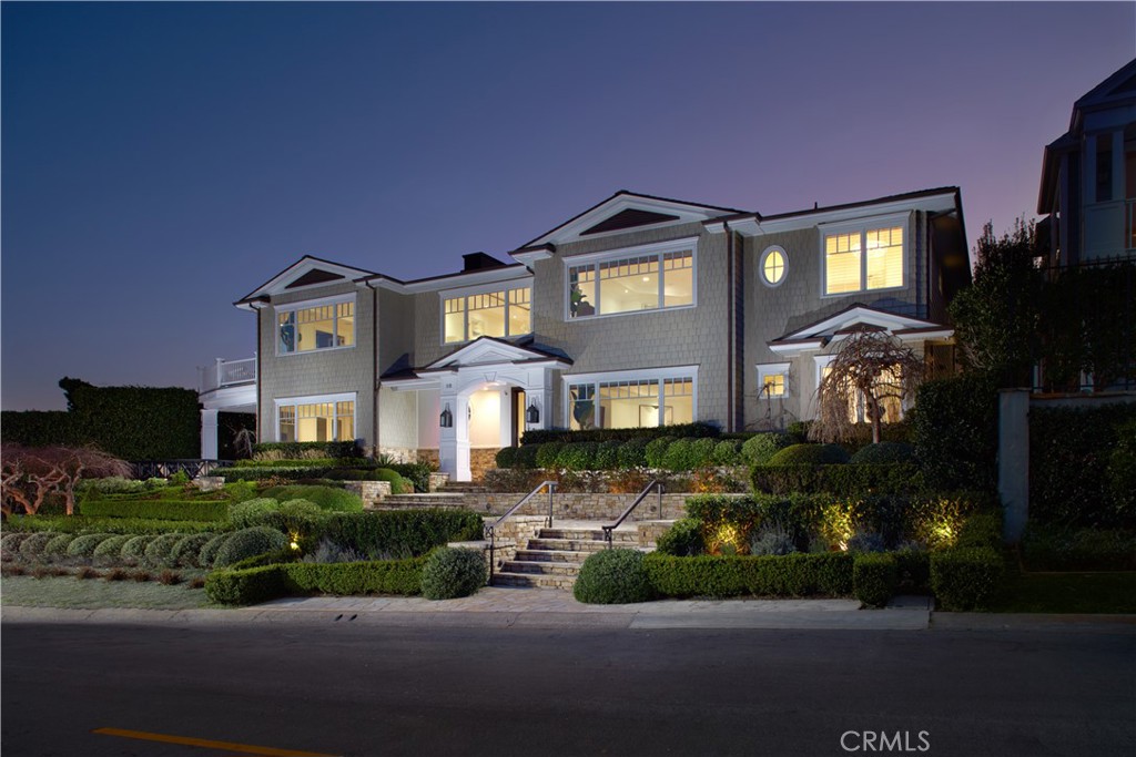 Poised at the end of an elevated cul-de-sac in Newport Beach’s highly coveted Cliffhaven enclave, this newly upgraded custom residence offers panoramic Newport Harbor, turning-basin, Pacific Ocean, Fashion Island, city-light and mountain views. Unparalleled curb appeal makes a grand first impression and is embellished with mature and manicured landscaping that complements the estate’s New England Shingle-inspired architecture. Sprawling grounds on the oversized homesite reveal sunny patios, stone terraces and a courtyard with spa, built-in BBQ, and a fire pit with built-in seating. Approximately 7,567 square feet, the two-level residence presents six ensuite bedrooms and is intelligently designed to maximize views by placing main living areas on the top level. Centered around a graceful spiral staircase, the first level showcases a foyer with classic Dutch entry door, a stunning wood-paneled executive office with coffered ceiling, a bright and spacious fireplace-warmed great room with kitchenette and wet bar, a wine cellar, and three bedrooms including a secondary primary suite with double doors, a fireplace, walk-in closet and soaking tub. Many spaces on this level open to the private courtyard. Crowned by skylight, the spiral staircase is joined by two additional staircases and an elevator that provide passage to the upper level, where memorable formal and casual gatherings are sure to be remembered by all who attend. The living and dining rooms are generously sized, and the family room and kitchen area is illuminated by large view-enriched windows. Anchored by a massive marble-topped island, the new chef-caliber kitchen displays white cabinetry, a built-in desk, two sinks, and top appliances including a Wolf range and a built-in refrigerator. The butler’s pantry boasts a Miele coffee station, a warming drawer and a beverage refrigerator. Sequestered behind double doors in its own second-floor wing, the primary suite features a fireplace, soaking tub, sit-down vanity, two water closets, and an oversized cedar-lined dual-entry walk-in closet with safe and washer/dryer set. Enjoy fireside gatherings on the roof-top deck, where 360-degree views are without equal. Lutron lighting, a multi-camera security system, handcrafted millwork, stone fireplaces, newly finished hardwood flooring, new luxury carpet, fresh paint, and an oversized tandem 4-car garage with golf cart stall and private entry lend added appeal.