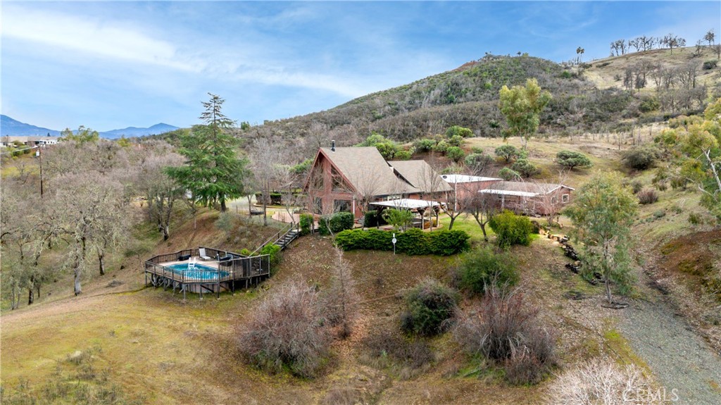 Welcome to 2567 Hendricks Rd, a versatile and picturesque country property spanning approximately 15.4+/- acres. As you enter through the private gated entrance, you'll be welcomed by a paved driveway leading to a spacious 3-car RV garage with 220V power, covered 24' RV parking with hookups, and a detached shop. The charming Tahoe-styled A-frame home features 1,865+/- square feet of living space, highlighted by soaring 30-foot ceilings and abundant view windows that fill the interior with natural light. The home is perfect for getting the family and friends together and features generously sized bedrooms, open floor plan with picture view windows, new Mini-Split heating and cooling systems, new water heaters, and a new well pump with a whole-house filtration system. Outside, enjoy a beautifully landscaped yard, an above-ground pool, and a covered gazebo with an outdoor kitchen, ideal for hosting gatherings. The property offers stunning views of Scotts Valley, providing a tranquil backdrop for both entertainment and quiet evenings. There is also a detached 600+/- Sq.FT. ADU that is currently rented out on a leased agreement. Situated just 5 minutes from downtown Lakeport, this property invites you to experience its beauty and serenity.