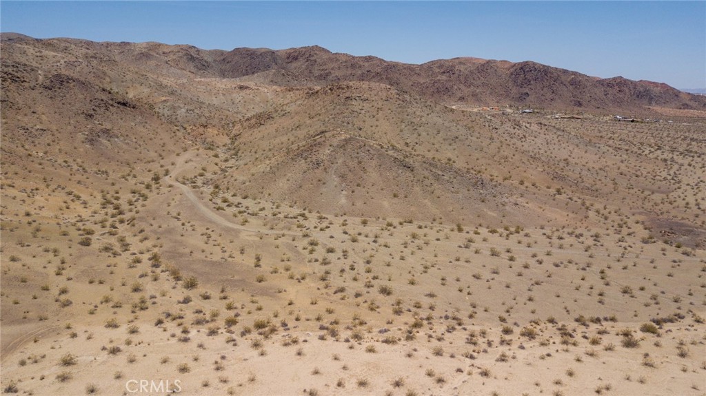 Located just a few miles off Highway 62, this 10-acre parcel in 29 Palms offers a perfect blend of seclusion and accessibility. The land is characterized by its open, expansive terrain, typical of the high desert landscape. The parcel enjoys stunning panoramic views of the surrounding mountains and desert plains, providing a serene and picturesque setting. The area is known for its clear skies, making it ideal for stargazing. Despite its tranquility, the property remains conveniently close to the amenities of 29 Palms, including shops, restaurants, and services. Additionally, it offers easy access to Joshua Tree National Park, a renowned destination for hiking, rock climbing, and nature exploration. This parcel presents a unique opportunity for those looking to build a private retreat, vacation home, or simply invest in the growing appeal of the 29 Palms area.